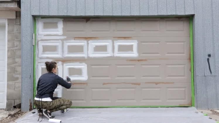 Person painting garage door